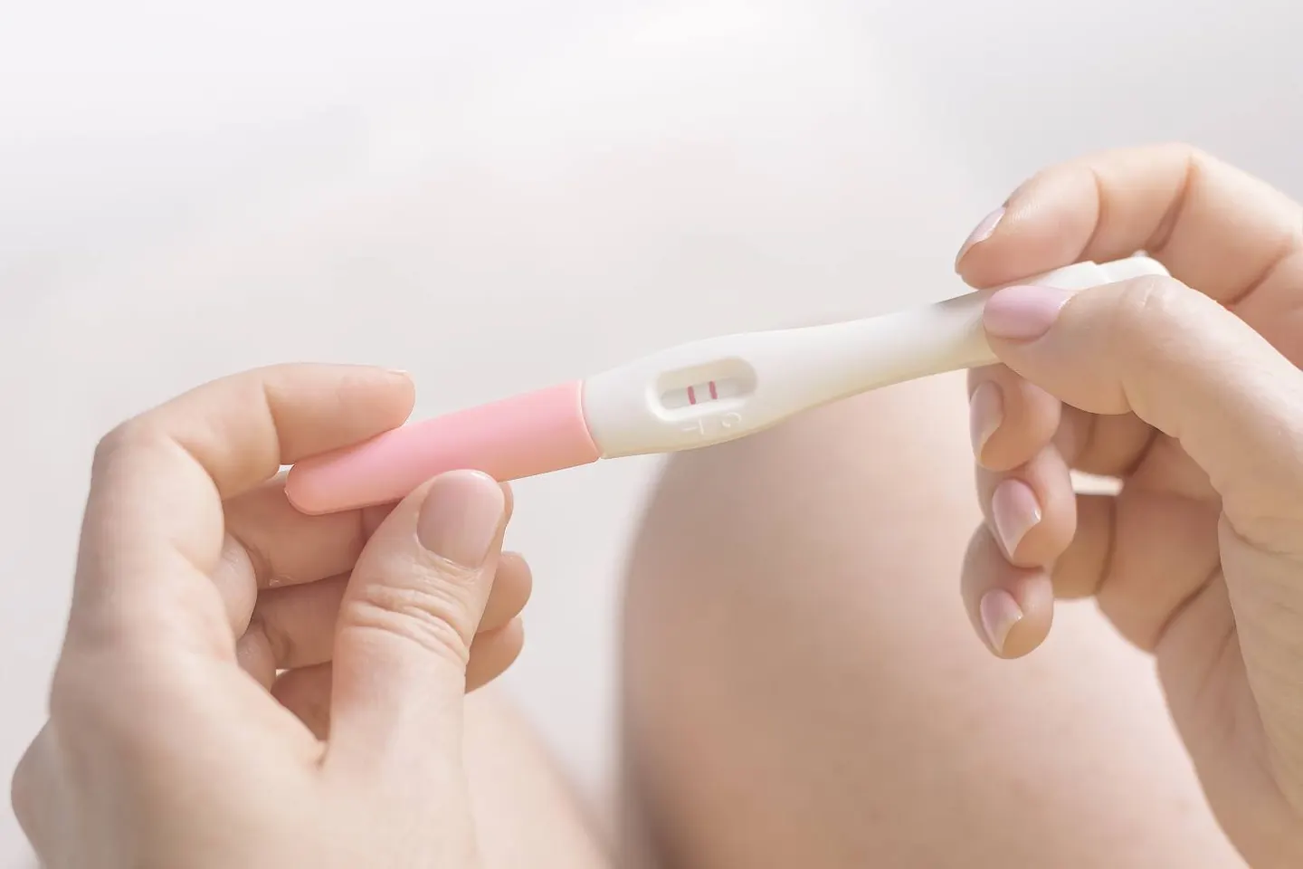 Hands holding a pregnancy test