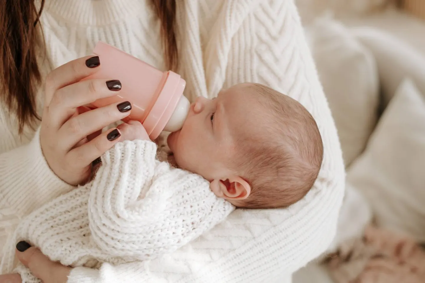 A baby being bottle fed, made possible by generous gifts