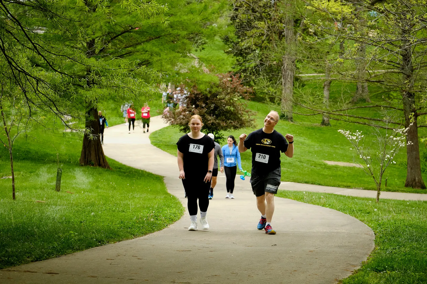 Participants walking a park path at the 2025 5K Walk/Run for Life