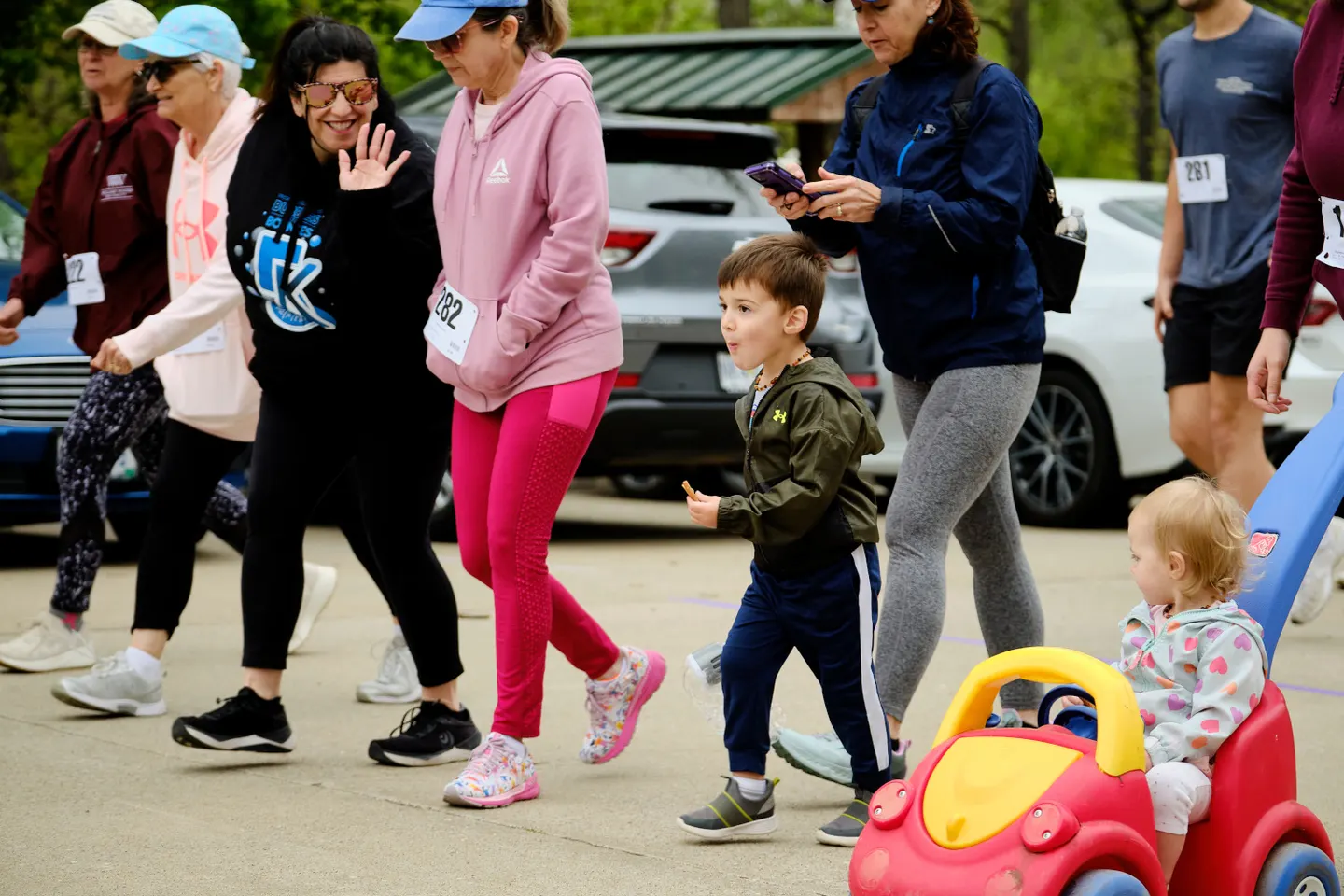 Families walking with race bibs at the 2025 5K Walk/Run for Life